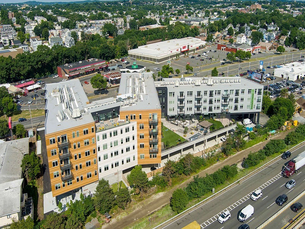 an aerial view of a city with buildings and cars